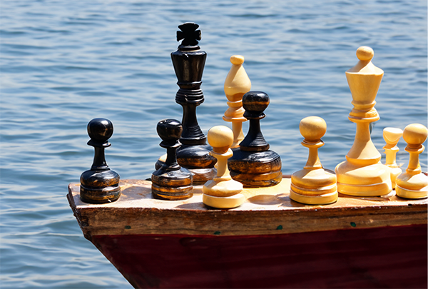 These chess pieces have existential dread. Chess pieces on a boat.